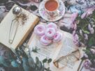 Pexels image of desserts, flowers, and a cup of tea on top of an open book.